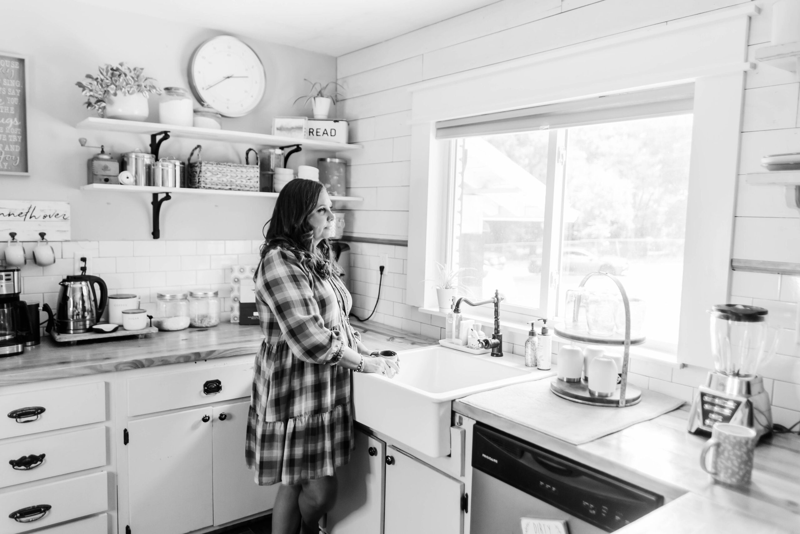 Ericka Watson, founder of Kindred Abbey, stares out the window of her kitchen.